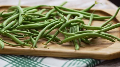 Flat lay view of raw French beans piled on a wooden background Stock Footage 343555523