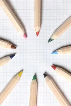 Flat lay view of white notebook , color pencils on a table. Stock Photos