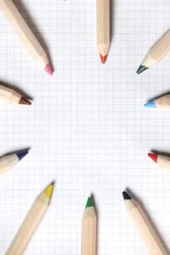 Flat lay view of white notebook , color pencils on a table. Stock Photos