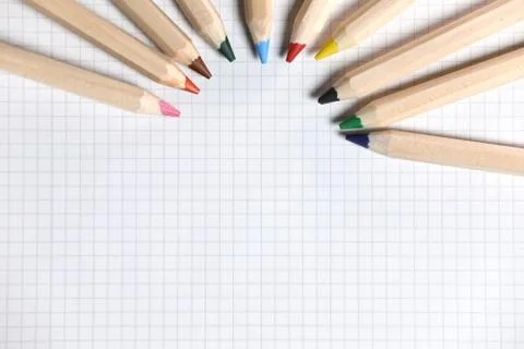 Flat lay view of white notebook , color pencils on a table. Stock Photos