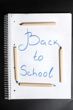 Flat lay view of white notebook , color pencils on a table. Stock Photos