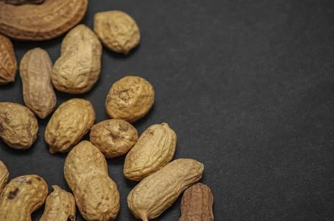 Flat lay wave shape of roasted unsalted peanuts, peanuts in skin and peanuts  Stock Photos