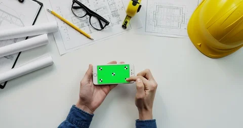 Flat lay of the white desk with constructor's stuff on which male hands Stock Footage 96042388