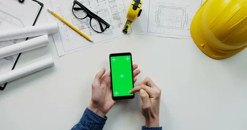 Flat lay of the white desk with constructor's stuff on which male hands Video stock 96042880