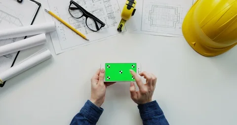 Flat lay of the white desk with constructor's stuff on which female hands 스톡 동영상 96044817