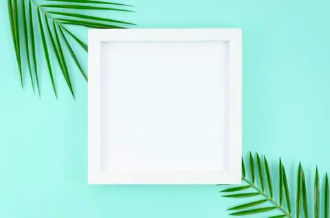 Flat lay white frame with copy space at blank paper list at light blue Stock Photos