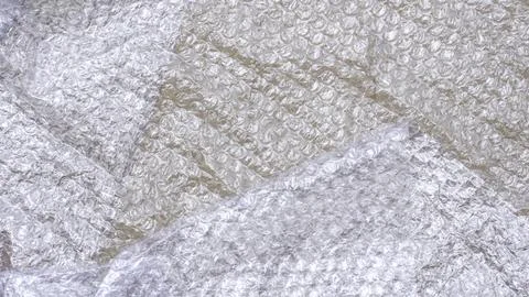 Flat lay of white plastic bubble wrap on cardboard paper sheet background Stock Photos