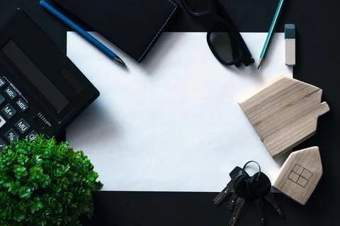 Flat lay with white sheet paper in center on black Stock Photos