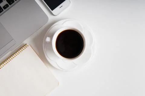 Flat lay on white wooden workspace with laptop computer, cell phone gadget an Stock Photos