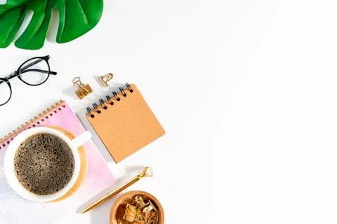 Flat lay of white working table place background with cup of coffee putting on Stock Photos