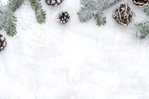 Flat lay winter composition made of fir branches, cones and snowflake on white Stock Photos