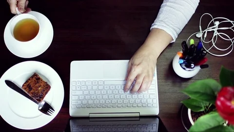 Flat lay of woman typing on tablet and drinking tea Video stock 83232382