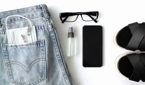 Flat lay of women's things and accessories on a white background. Blue jeans Stock Photos
