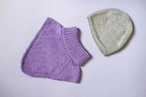 Flat lay woolen winter clothing. Top view sweater and hat. Stock Photos