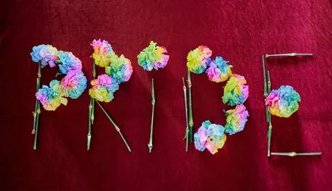Flat lay word Pride made from colorful flowers, LGBTQ symbol Stock-Fotos