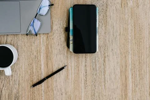 Flat lay of the workplace. Freelance work laptop smartphone and note pad Stock Photos