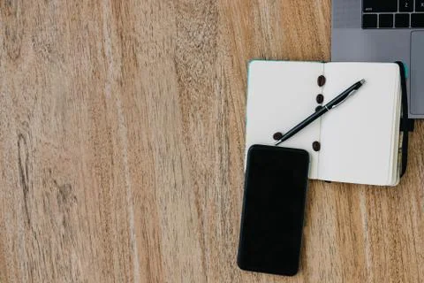 Flat lay of the workplace. Freelance work laptop smartphone and note pad Stock Photos
