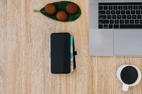 Flat lay of the workplace. Freelance work laptop smartphone and note pad Stock Photos