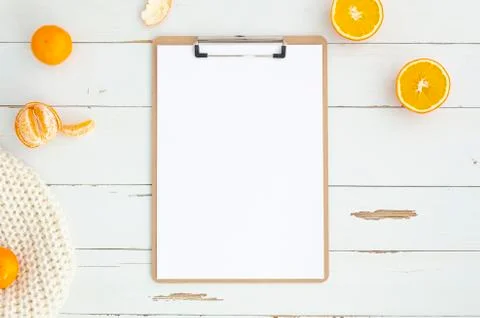 Flat lay workspace with a clipboard on white wooden planks. Mockup with copy Stock Photos
