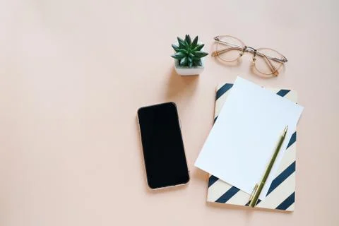 Flat lay of workspace desk, minimal stationery with smartphone Stockfoto's