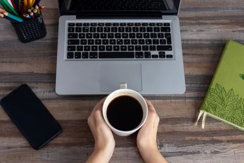 Flat lay workspace desk top view: laptop keyboard, phone, notebook Stock Photos