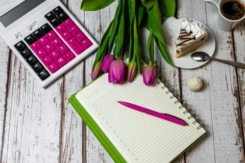 Flat lay workspace notepad and pen, financial sphere calculator, celebratory  Stock Photos