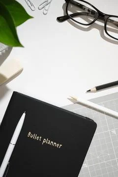 Flat lay workspace with planner, eyeglasses, pencils and office supplies on.. Stock Photos