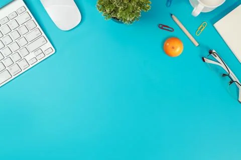 Flat lay workspace table with laptop computer on blue background Stock Photos