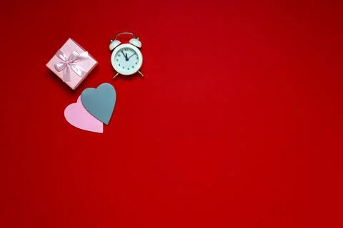 Flat lay on workspace time for valentine's day on red background, heart gifts Stock Photos