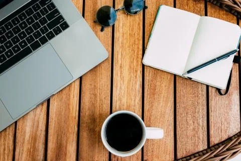 Flat lay of workspace for working at a laptop, on a brown wooden table Stock Photos