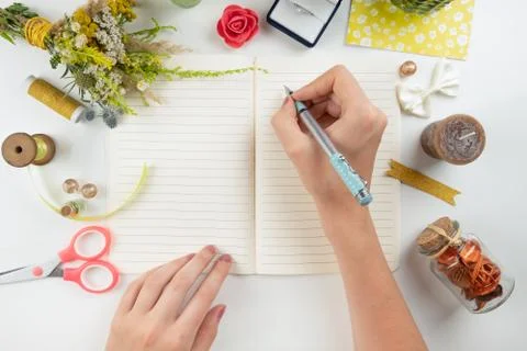 Flat lay of writing memories and emotions into diary. Stock Photos