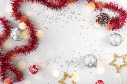 Flat lay xmas composition with empty space. Red tinsel, golden stars and silver Stock Photos