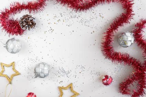 Flat lay xmas composition with empty space. Red tinsel, golden stars and silver Stock Photos