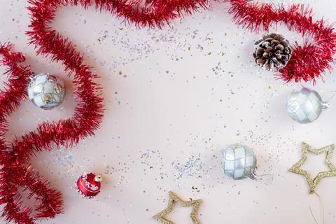 Flat lay xmas composition with empty space. Red tinsel, golden stars and silver Stock Photos