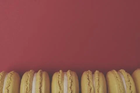 Flat lay yellow macaroons on red background Stock Photos