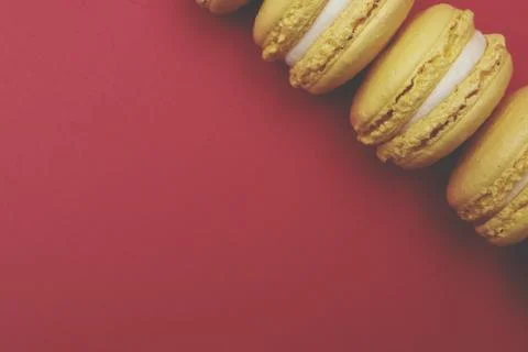 Flat lay yellow macaroons on red background Stock Photos