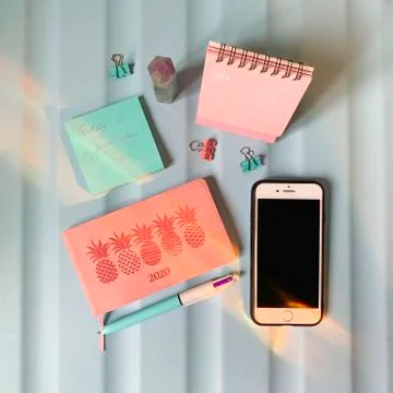 Flat layout of blank notepad with pen and stickers on colorful background Stock Photos