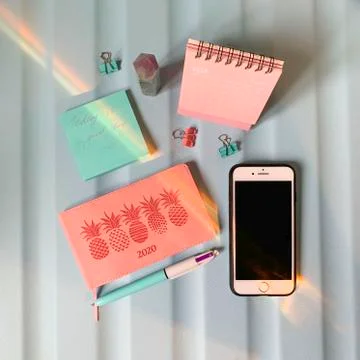 Flat layout of blank notepad with pen and stickers on colorful background Stock-Fotos