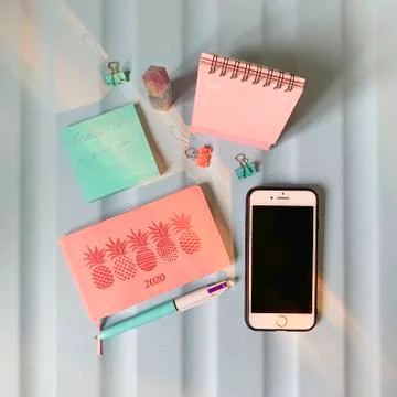 Flat layout of blank notepad with pen and stickers on colorful background Stock Photos