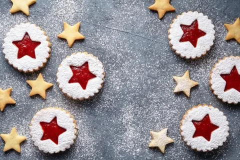 Flat layout of festive handmade cookies star on the dark surface. Top view Stock Photos