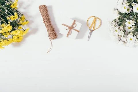 Flat layout of tied present box next to bouquets 库存照片