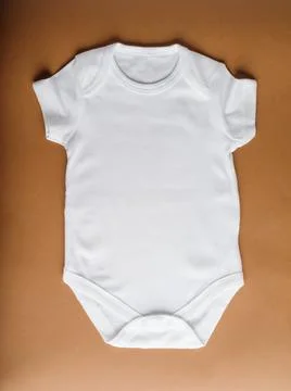 Flat layout of white bodysuit - the first basic clothing for newborns made fr Stock Photos
