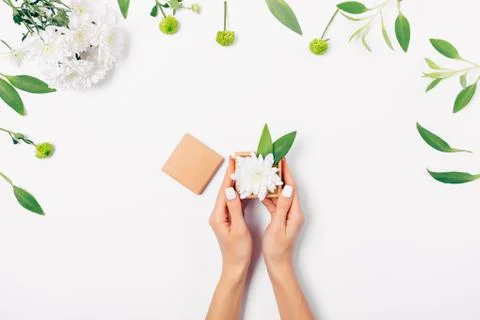 Flat layout woman's hands holding open small gift box Stock Photos