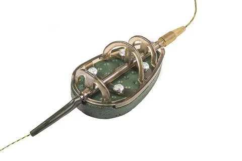 A flat method rig for carp fishing is displayed, featuring a weighted feeder  Stock Photos
