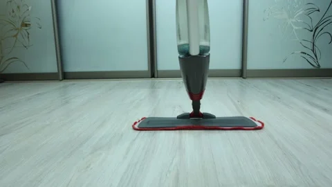 Flat microfiber spray mop for wet cleaning of wooden floor. Stock Footage 149531385