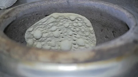 Flat middle eastern bread cooking in the oven Stock Footage 40974814