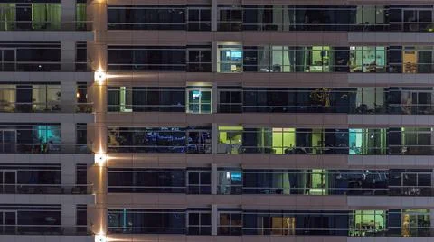 Flat night panorama of multicolor light in windows of multistory buildings ae Stock Photos
