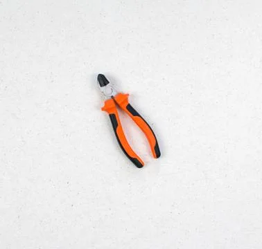 The flat-nose pliers with plastic case, handle isolated on a light background Stock Photos