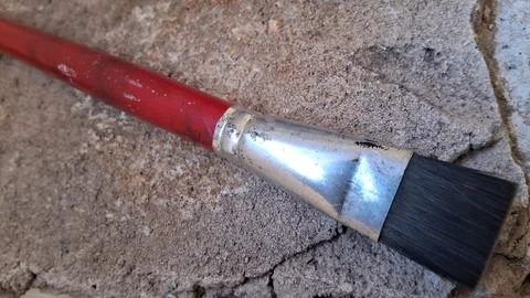 Flat paint brush on textured surface. Artist tool for painting and creative art Stock Photos