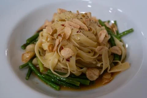 Flat Pasta with Garlic Chips and Green Vegetables Stock Photos